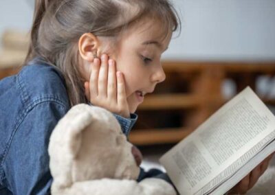 Child reading a book at the Reading Club, Carrick On Shannon library